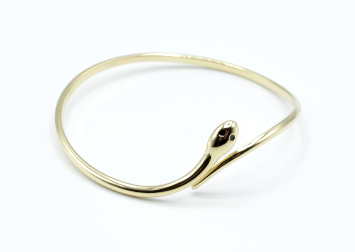 Brazalete Snake acero inoxidable dorado con forma de serpiente,  
dos circonitas, joya fina y elegante- delacabra