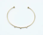 Brazalete Three Diamonds acero inoxidable dorado vista superior, extremos cuidadosamente acabados en dos bolas redondas perfectas - delacabra