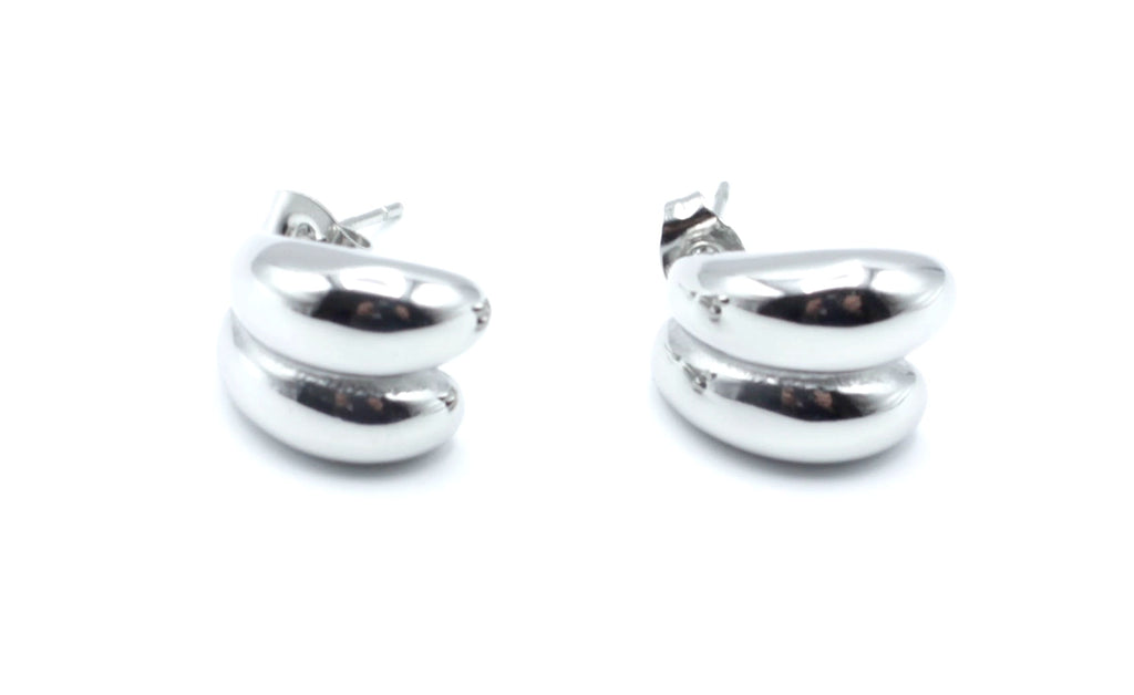 Pendientes Together acero inoxidable plateado con forma suave y redondeada, su acabado pulido y brillante realza el rostro. - DELACABRA