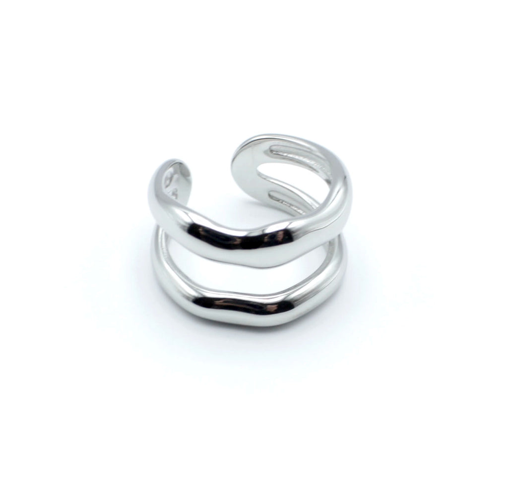 Anillo plateado con dos bandas curvas paralelas, de acero inoxidable brillante, diseño abierto y estructura ajustable.