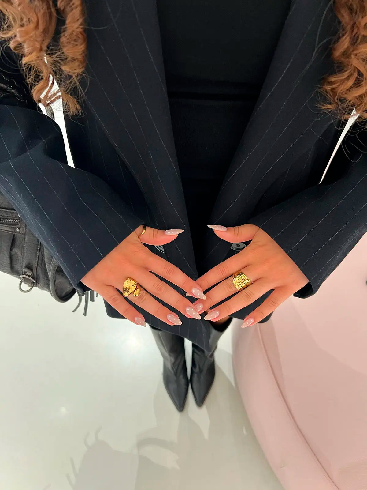 anillo marble acero inoxidable ajustable, mujer elegante luciendo un traje oscuro en conjunto con anillos de Delacabra