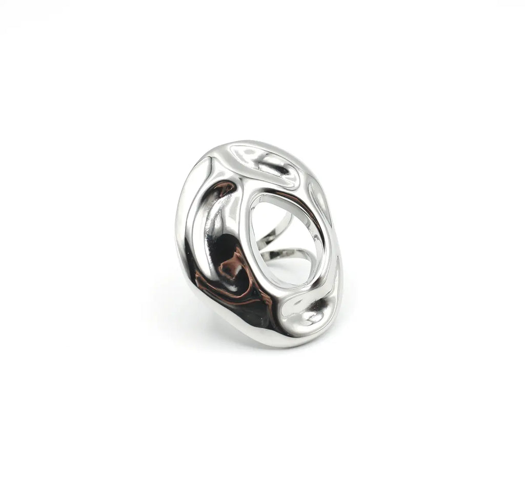 Anillo plateado de diseño ovalado con relieve fluido y hueco central. Joya de acero amable con la piel DELACABRA.