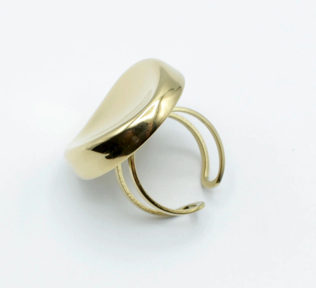 Anillo Zahara dorado ajustable de acero inoxidable visto en ángulo inclinado. Forma ovalada moderna, ideal para uso diario