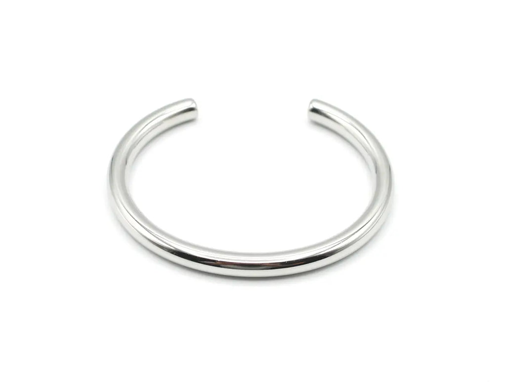Brazalete plateado Lia de acero inoxidable con diseño de caña rígida y pulido espejo. Joya amable con la piel DELACABRA.