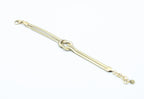 Brazalete Tangled acero inoxidable dorado entrelazado simulando un nudo llano, acabado suave y brillante - DELACABRA