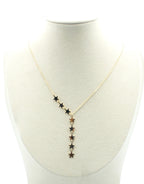 Collar dorado con cadena fina y estrellas colgantes, expuesto sobre busto claro.