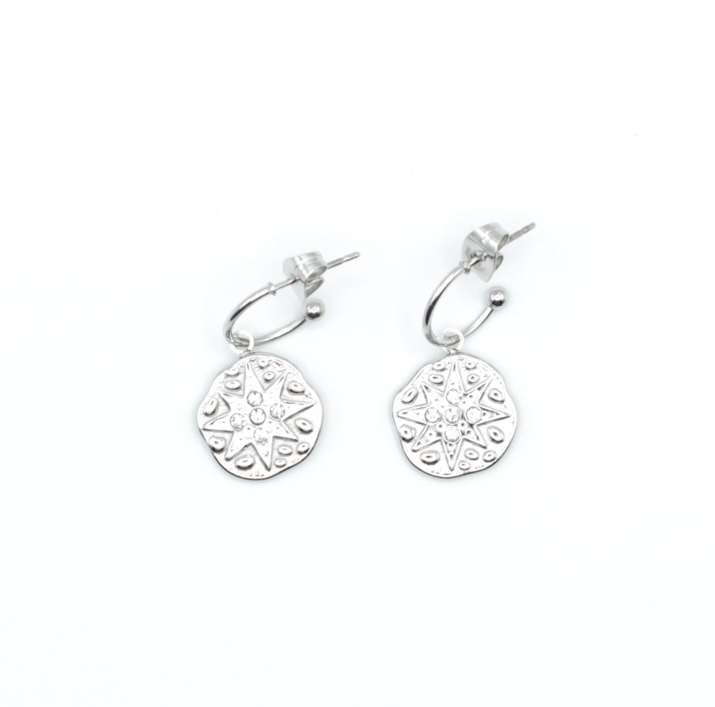 Pendientes Polar de aro abierto plateado con colgante circular grabado en forma de estrella, acero inoxidable hipoalergénico y resistente al agua, cierre mariposa.