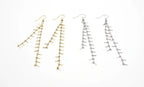 Pendientes largos de flecos en acero inoxidable, colores dorado y plateado, fondo blanco.
