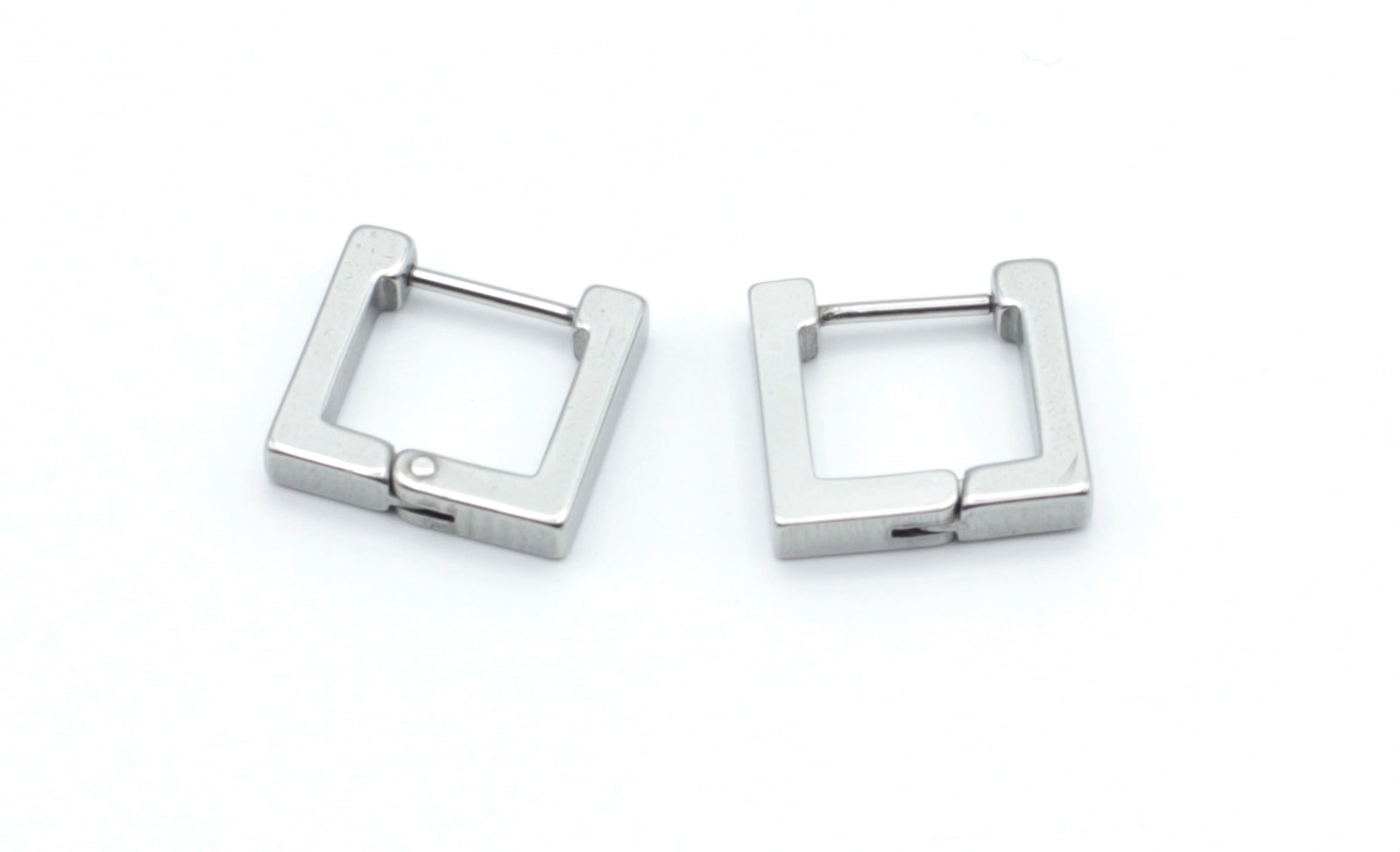 Pendientes Square en acero inoxidable plateado con forma de aro cuadrado, hipoalergénicos, resistentes al agua y muy duraderos. Cierre de bisagra seguro. DELACABRA